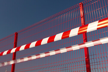 Striped red and white barrier tape. Restrictions due to the COVID-19 pandemic. Lockdown.