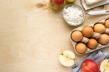 Bakery flat lay. Ingredients for cooking apple pie on wooden background, space for text