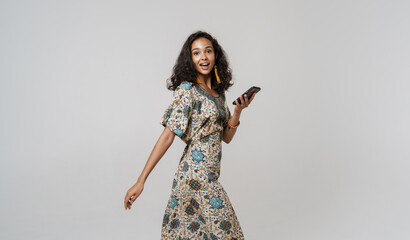 Young south asian woman wearing dress using mobile phone