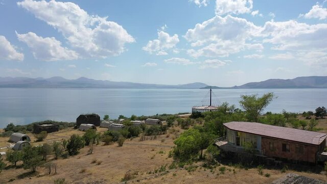 Abandoned buildings near water. Aerial footage unfinished buildings near lake Sevan, Armenia. 