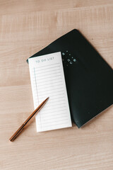 Workplace in office with wood desk. Top view from above of laptop with notebook and coffee. Space for modern creative work of a designer. Flat lay with blank copy space. Business and finance concept.
