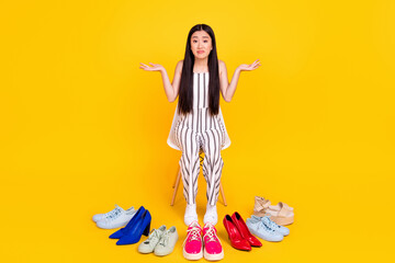 Full length body size photo girl cant choose footwear in shopping mall shrugging shoulders isolated vivid yellow color background