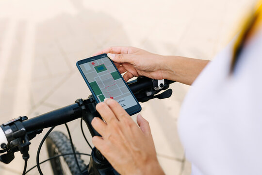 Delivery woman checking map on smart phone