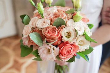 Classic bouquet of roses in the hands of the bride.
