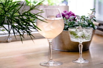 Gin cocktails on a wooden table in a restaurant near window