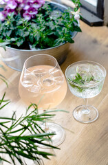 Gin cocktails on a wooden table in a restaurant near window