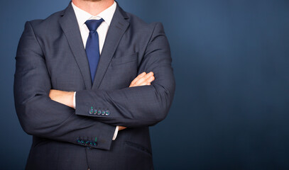 Businessman in suit standing with crossed arms