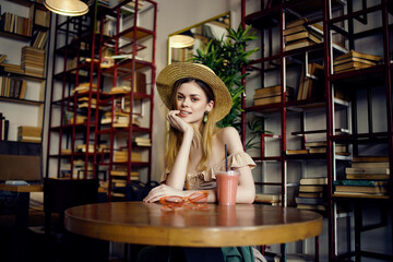 cheerful woman reading a book in a cafe fashion