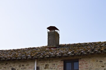 A ruined concrete chimney on the roof of a rural farmhouse (Umbria, Italy, Europe) - 459904809
