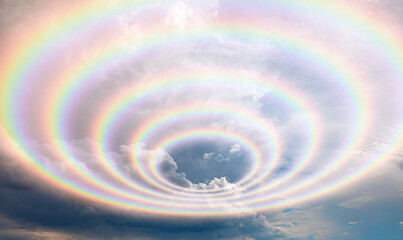 Amazing rainbow in the blue sky after the rain with lighting flare
