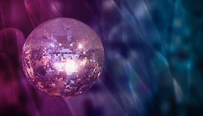 Party disco mirror ball reflecting purple lights