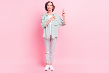 Full size photo of serious concentrated people hand on chest raise fingers isolated on pink color...