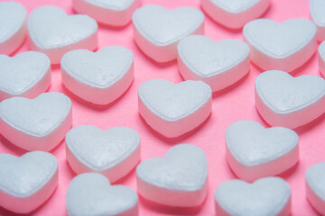 Obraz na płótnie Canvas Heart shaped pills on a pink background. Medicines for the heart and for blood vessels and lungs.