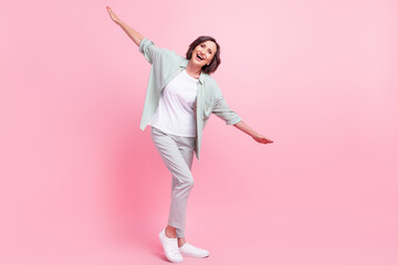 Full size photo of positive excited aged person arms flying have good mood isolated on pink color background