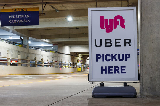 Lyft And Uber Pickup Spot At The Airport. Lyft And Uber Ride Sharing Has Replaced Many Taxi Cabs For Transportation.