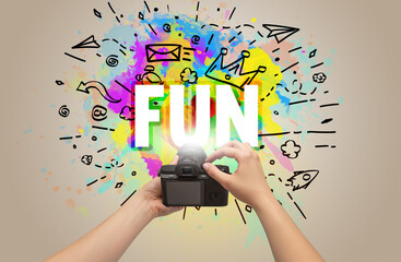 Close-up of a hand holding digital camera with abstract drawing