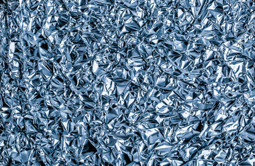 Abstract background shimmering texture metallic glitter foil. Crumpled foil as an unusual...