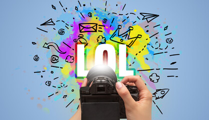 Close-up of a hand holding digital camera with abstract drawing