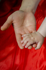 Close-up of parents and baby hands.