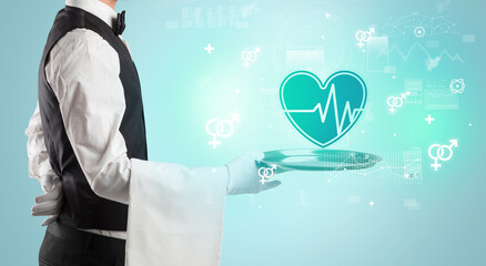 Obraz premium Handsome young waiter in tuxedo holding healthcare icons on tray