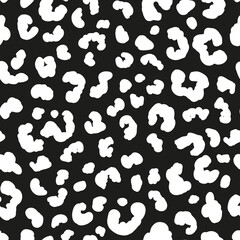 Monochrome leopard skin seamless repeat pattern. Random placed, vector spots animal all over print on black background.