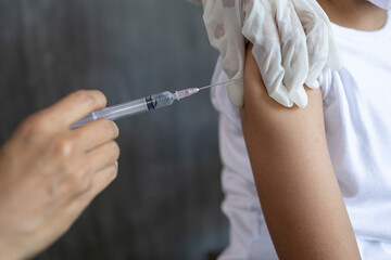 Close up Nurse vaccinating child on arm