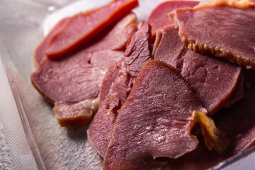 The Slices of Smoked Beef Tongues in the pack in the plastic pack sold by local supermarket in Japan on the table.