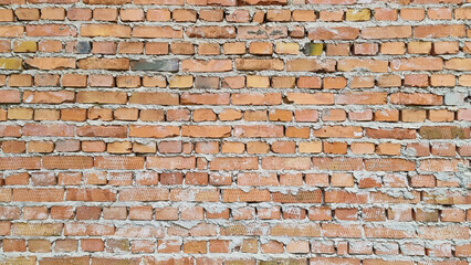 Naklejka premium Brick wall not plastered, masonry seams are visible.