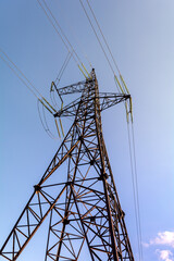 Electrical supports for high voltage cables. A metal support with high voltage insulators against the background of a clear sky. Electricity transmission.