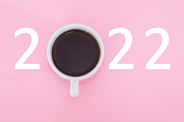 Cup of coffee with number 2022 on pink background