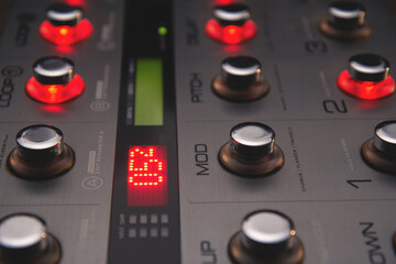 Foot controller in recording studio, work on music in progress: filter off, loops on (mod, pitch,...