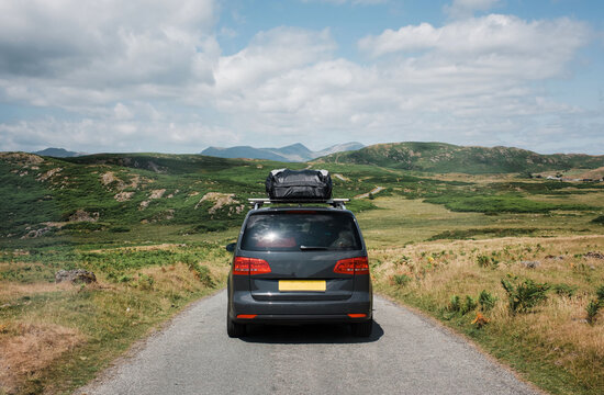 family car with roof box on the top going on an road trip in the UK