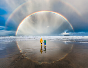 Circle rainbow in New Zealand with two children in center
