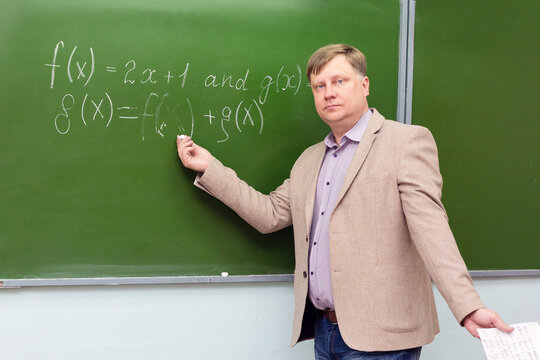 A strict math teacher at the blackboard explains the solution of the problem to students.