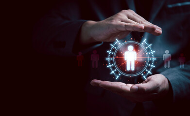 Businessman hand protecting to virtual human icon for focus customer group or human recruitment and...