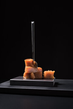 Gourmet quince jelly paste in ceramic plate on black background