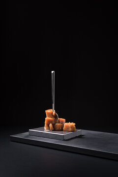 Gourmet quince jelly paste in ceramic plate on black background