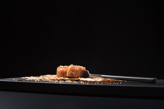 Gourmet quince jelly paste in ceramic plate on black background