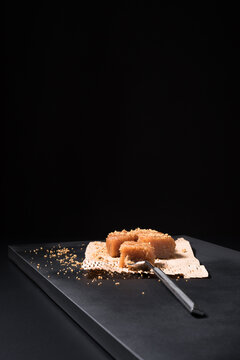 Gourmet quince jelly paste in ceramic plate on black background