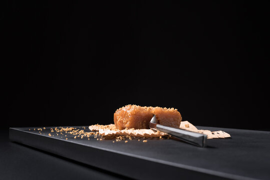 Gourmet quince jelly paste in ceramic plate on black background