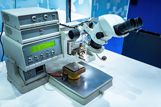 Microscope for PCB examination. Microscope in electro-technical laboratory. Microchip testing equipment. Checking microchips before production. Study microprocessor. PCB testing. Electron microscope