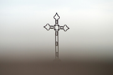 Silhouette of Cross in the fog 