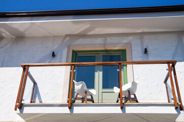 Open balcony with white armchairs