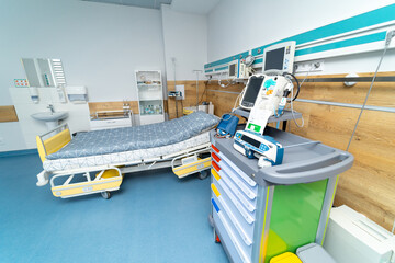 Adjustable patient bed in hospital room. Empty modern hospital ward with new technologies.