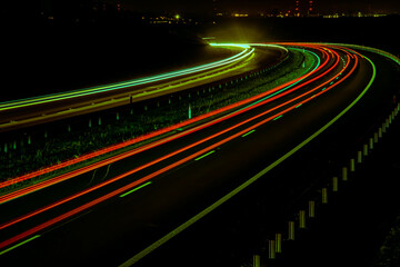 Night road lights. Lights of moving cars at night. long exposure red, blue, green, orange.