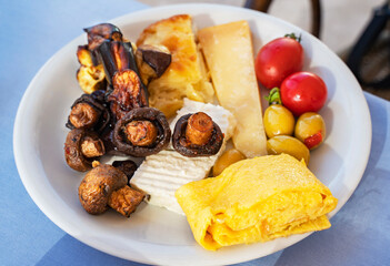 Delicious breakfast, mushrooms vegetables and scrambled eggs.