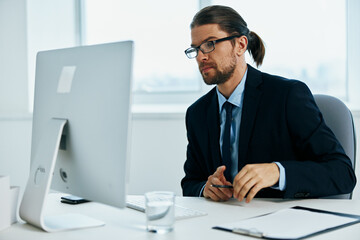 Fototapeta premium man in a suit an official is working at the computer technologies