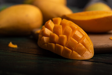 Cut and complete mangoes on the chopping board