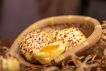 Cut and complete the egg yolk steamed stuffed bun on the wood grain table