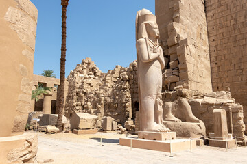 The statue of Ramses II with his daughter Merit-Amon in the temple of Amun-RA in Karnak, Luxor,...